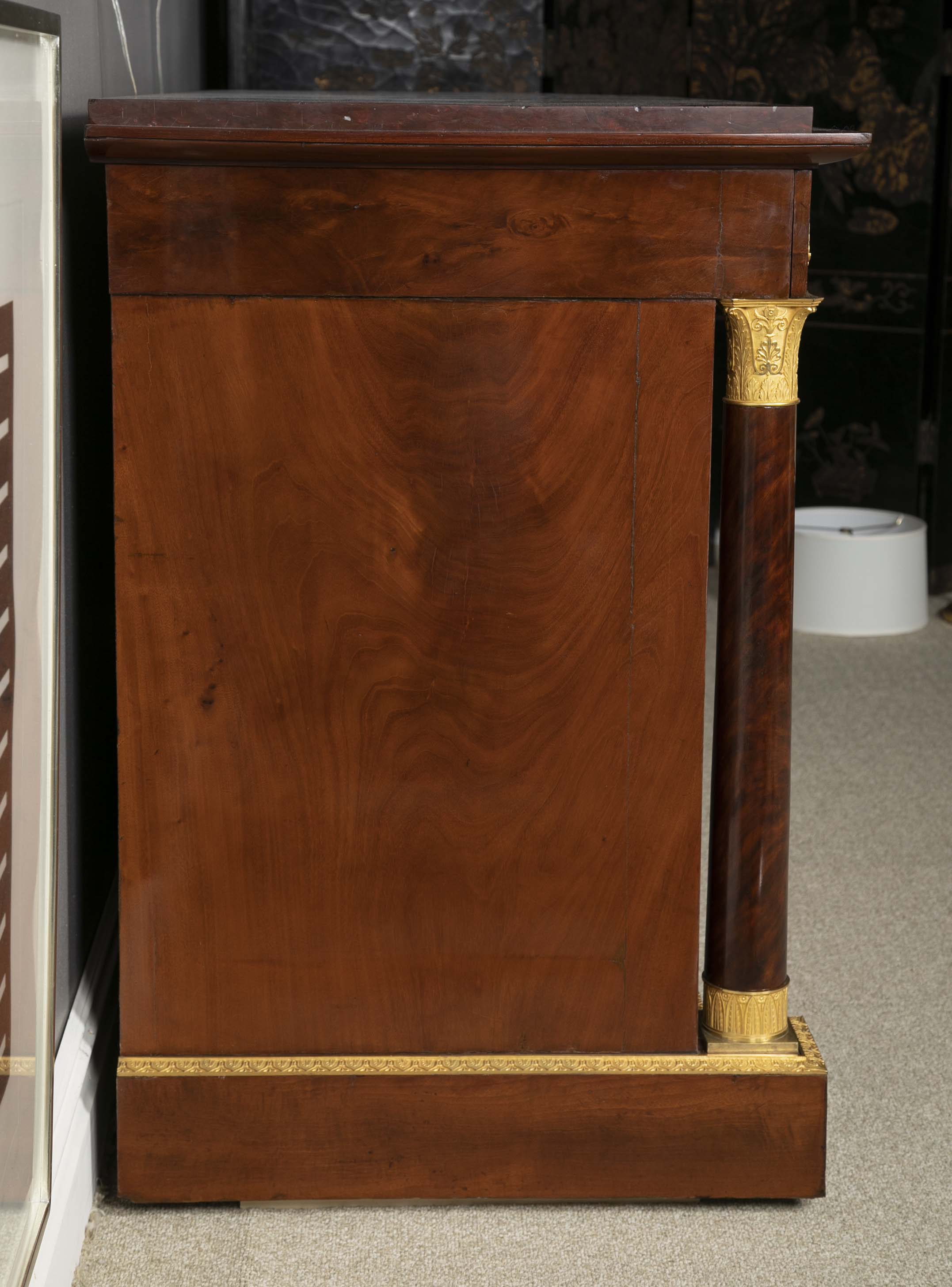 A Molitor French Empire Flame Mahogany and Gilt Bronze Commode with Rouge Griotte