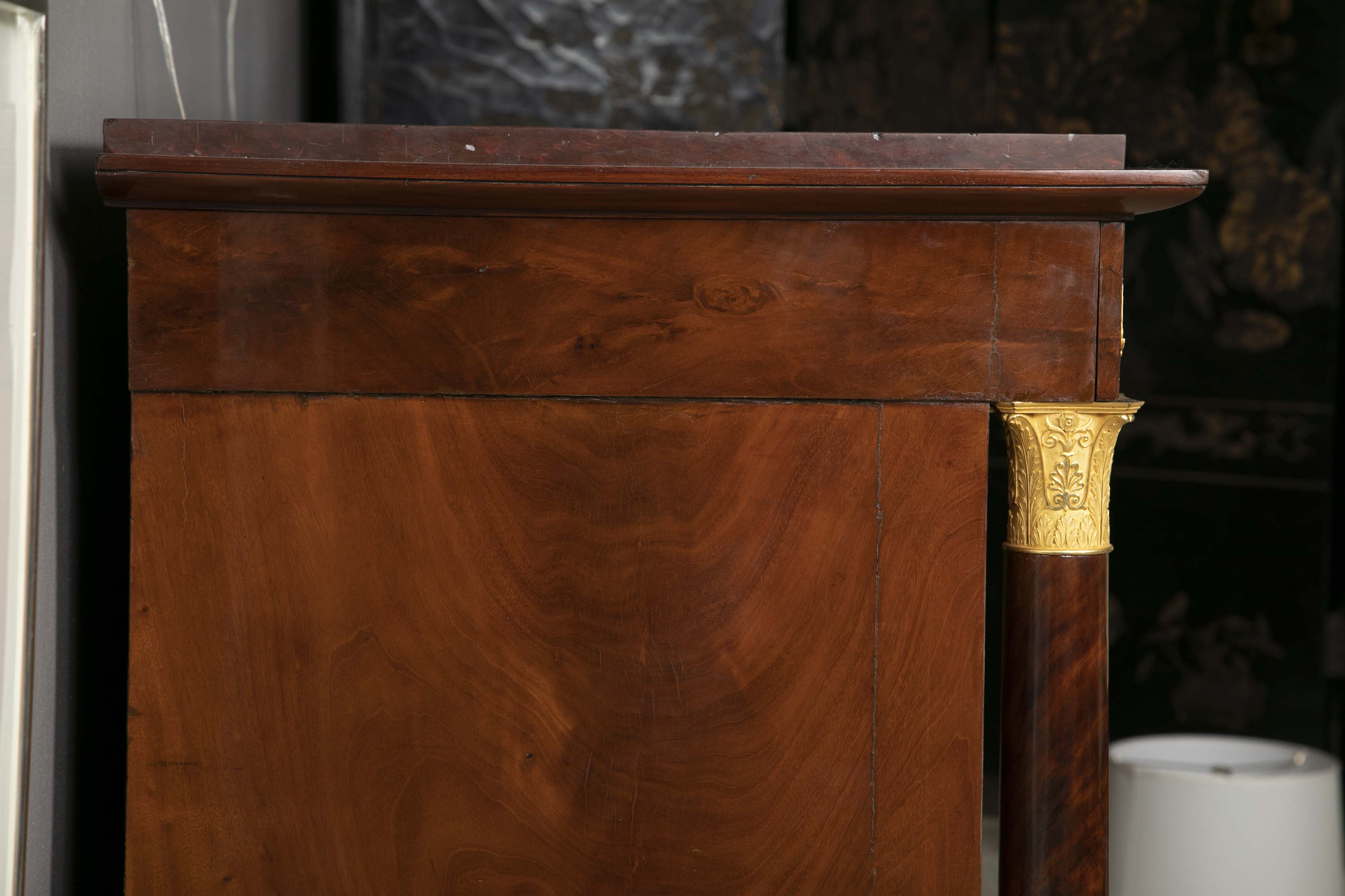 A Molitor French Empire Flame Mahogany and Gilt Bronze Commode with Rouge Griotte