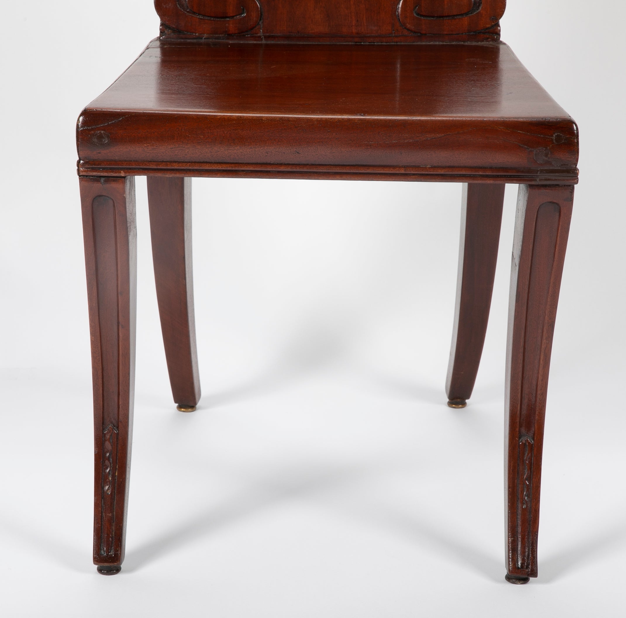 A Pair of Late Georgian Mahogany and Polychrome Hall Chairs