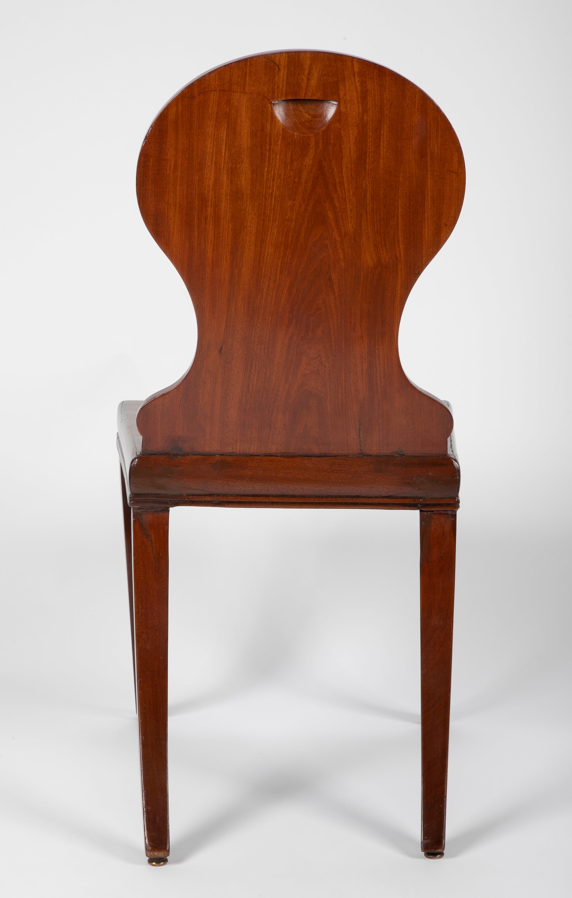 A Pair of Late Georgian Mahogany and Polychrome Hall Chairs