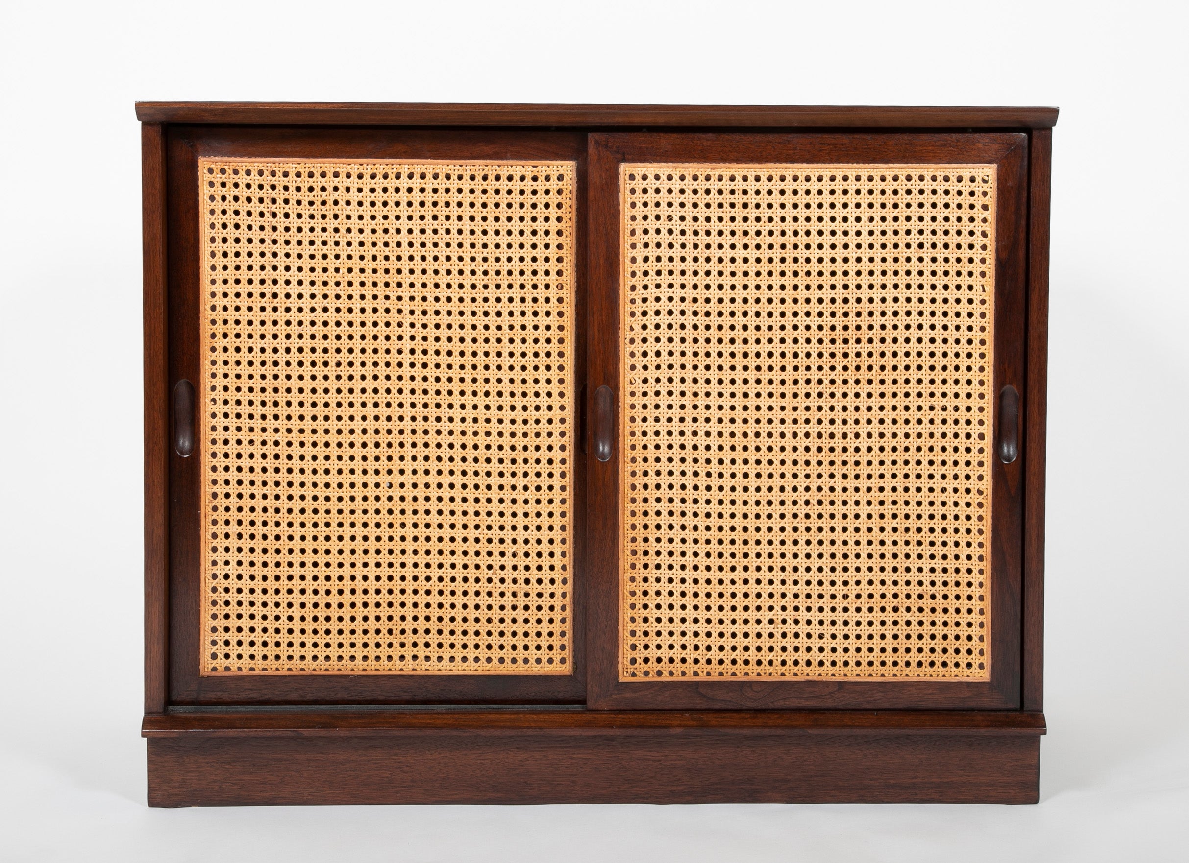 A Pair of Walnut Cabinets with Cane Fronted Sliding Doors