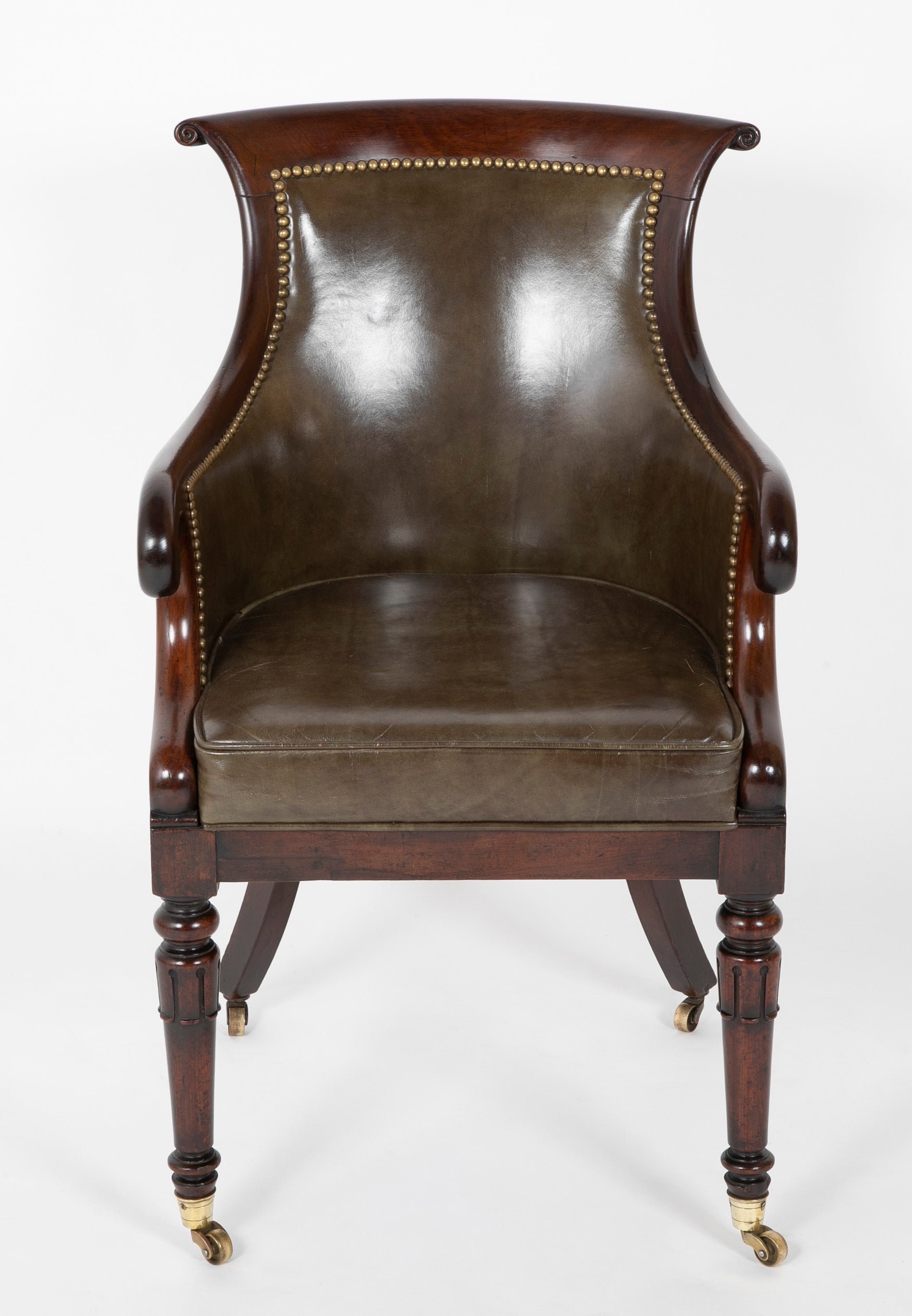 A Mahogany Library Chair with Curled & Carved Crest Upholstered in Leather