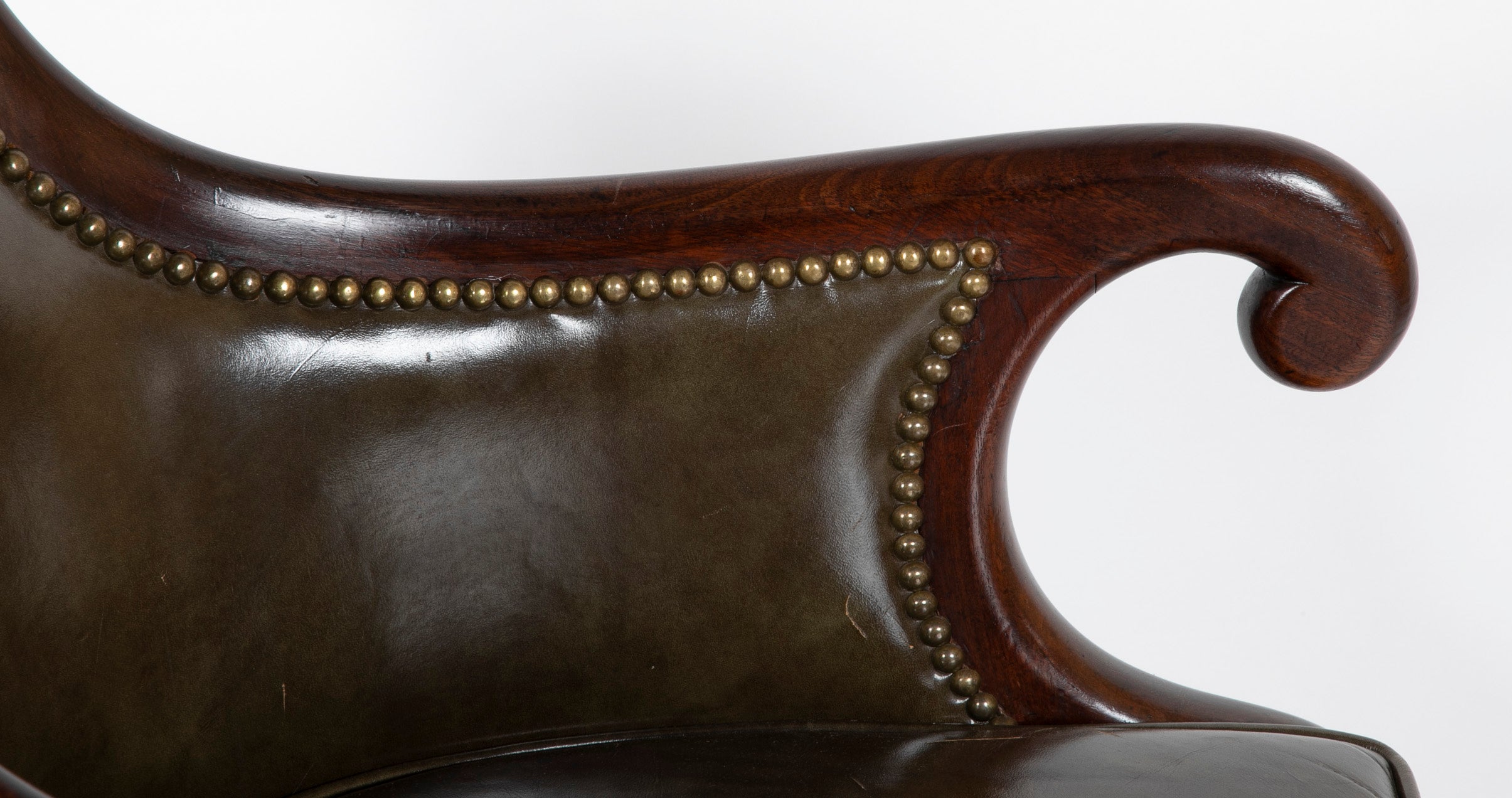 A Mahogany Library Chair with Curled & Carved Crest Upholstered in Leather
