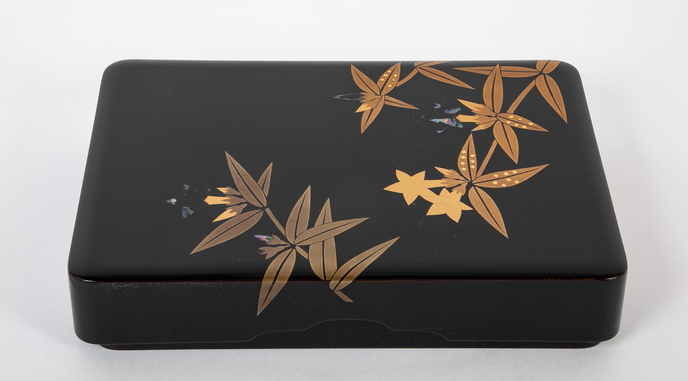 A Wajima Lacquered Covered Box with Gilt Leaf Decoration