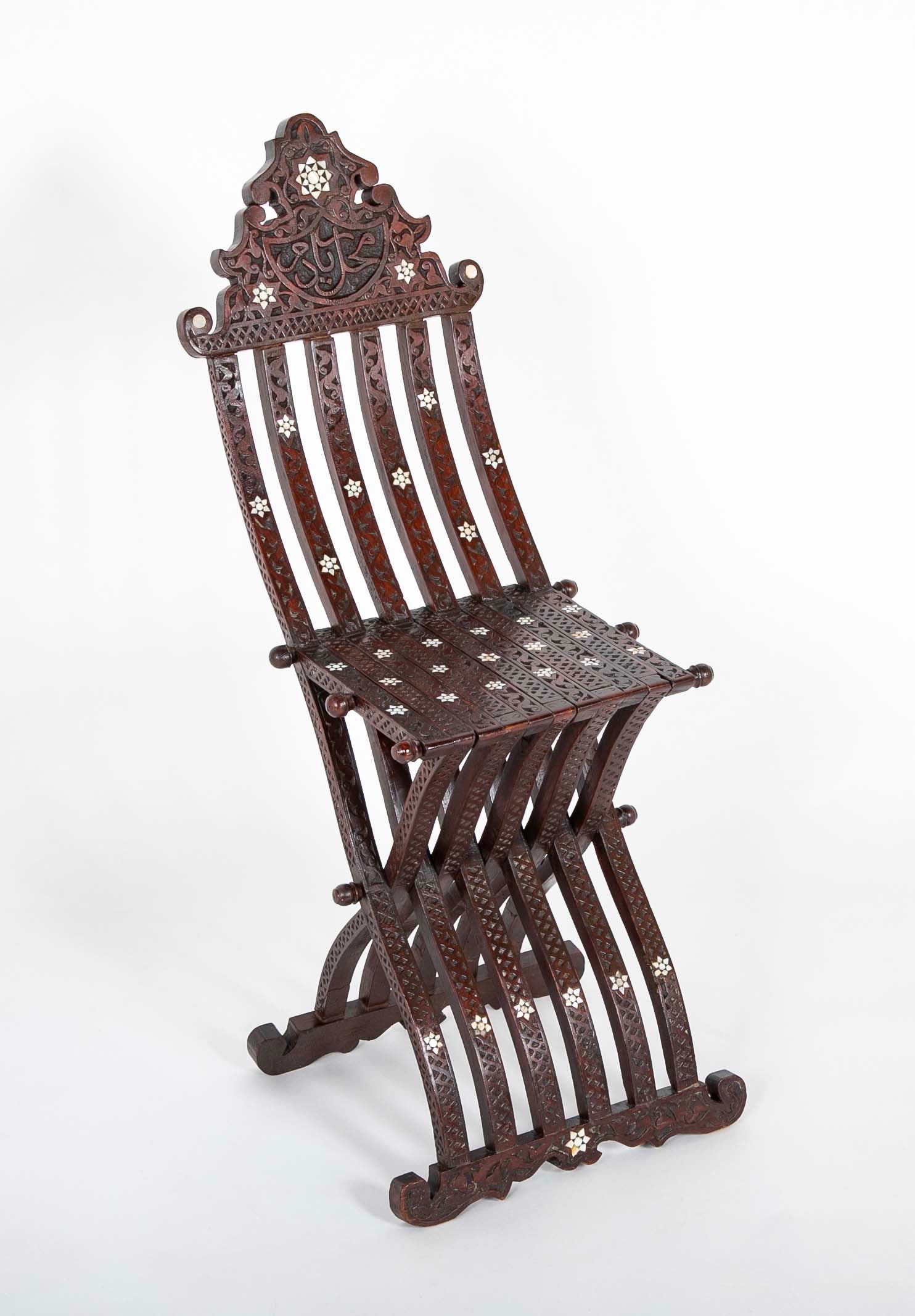 A Syrian Carved Hardwood Folding Chair with Abalone Inlays