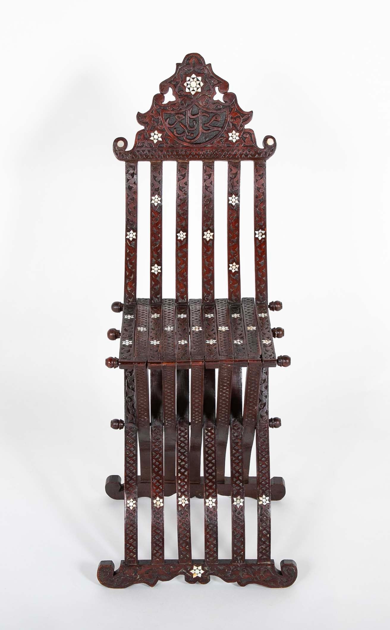 A Syrian Carved Hardwood Folding Chair with Abalone Inlays