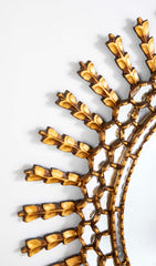 A Sunburst Oval Mirror with Leaf Forms on Rays