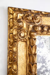 A Deeply Carved Continental Giltwood Mirror