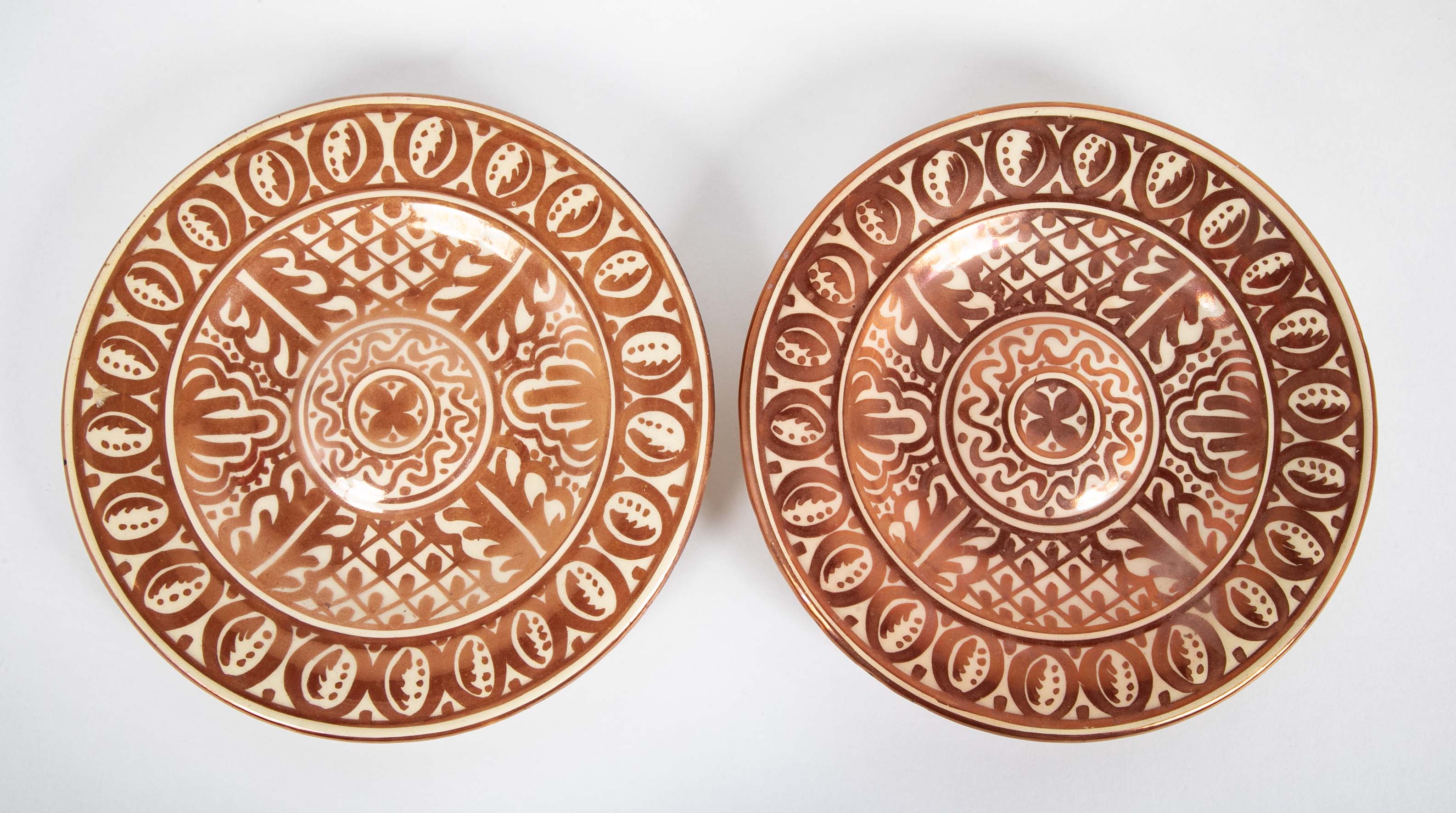 Two Round Copper Lustre Plates with Stylized X Design