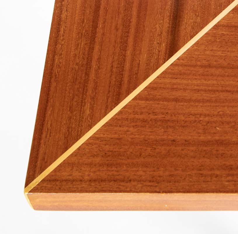 A Tommi Parzinger For Charak Modern Mahogany and Maple Dining Table With Leaves.