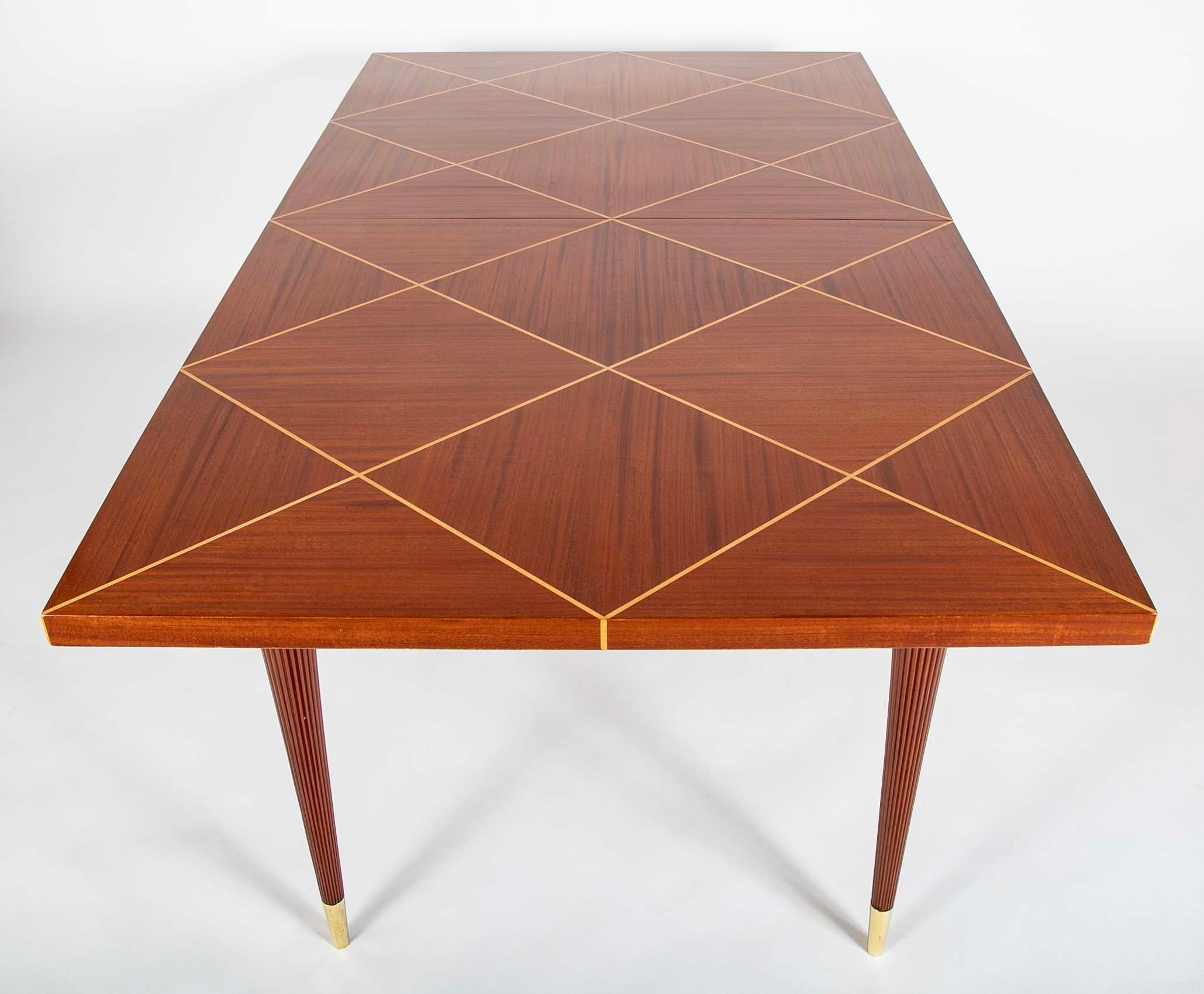 A Tommi Parzinger For Charak Modern Mahogany and Maple Dining Table With Leaves.