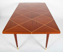 A Tommi Parzinger For Charak Modern Mahogany and Maple Dining Table With Leaves.