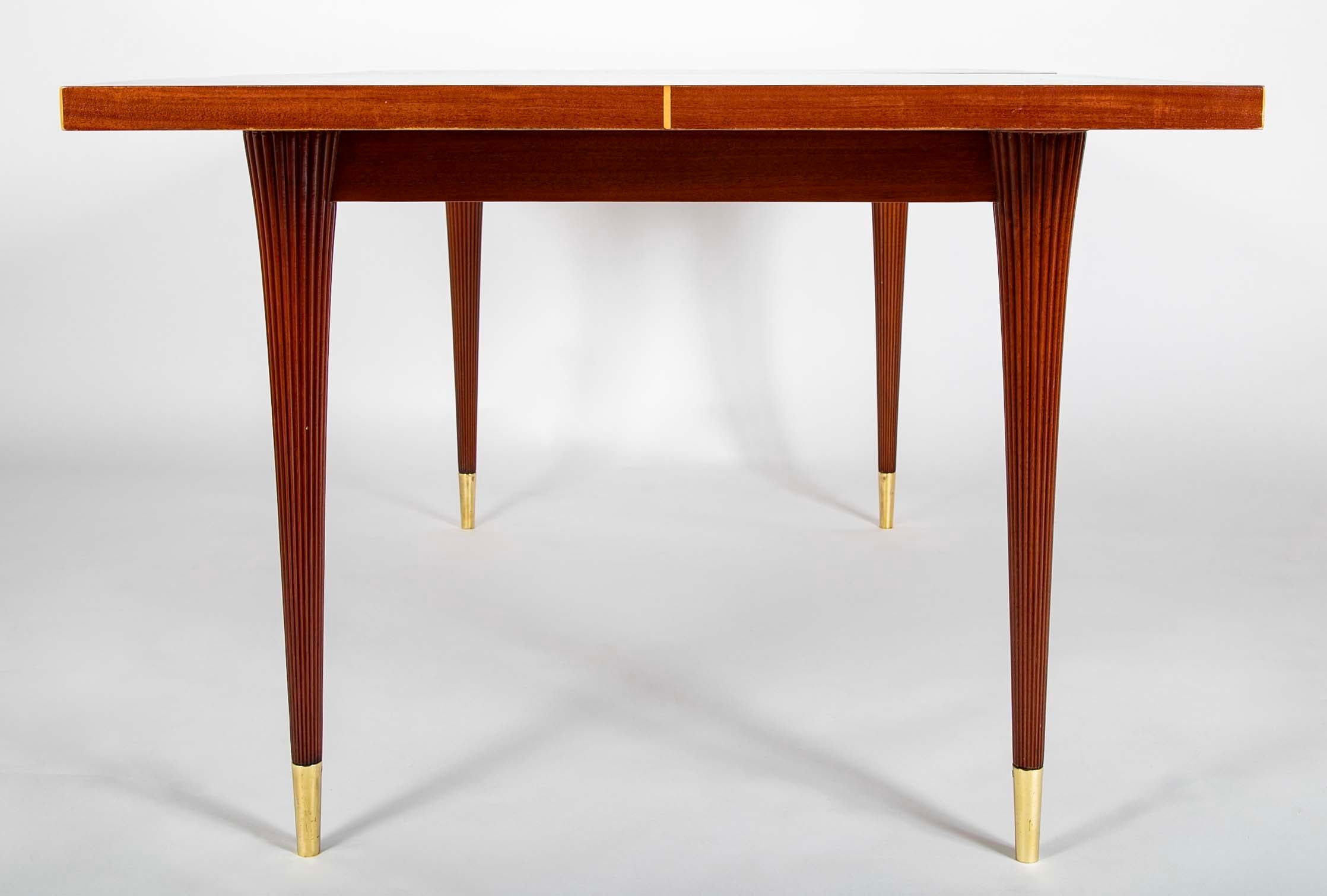 A Tommi Parzinger For Charak Modern Mahogany and Maple Dining Table With Leaves.