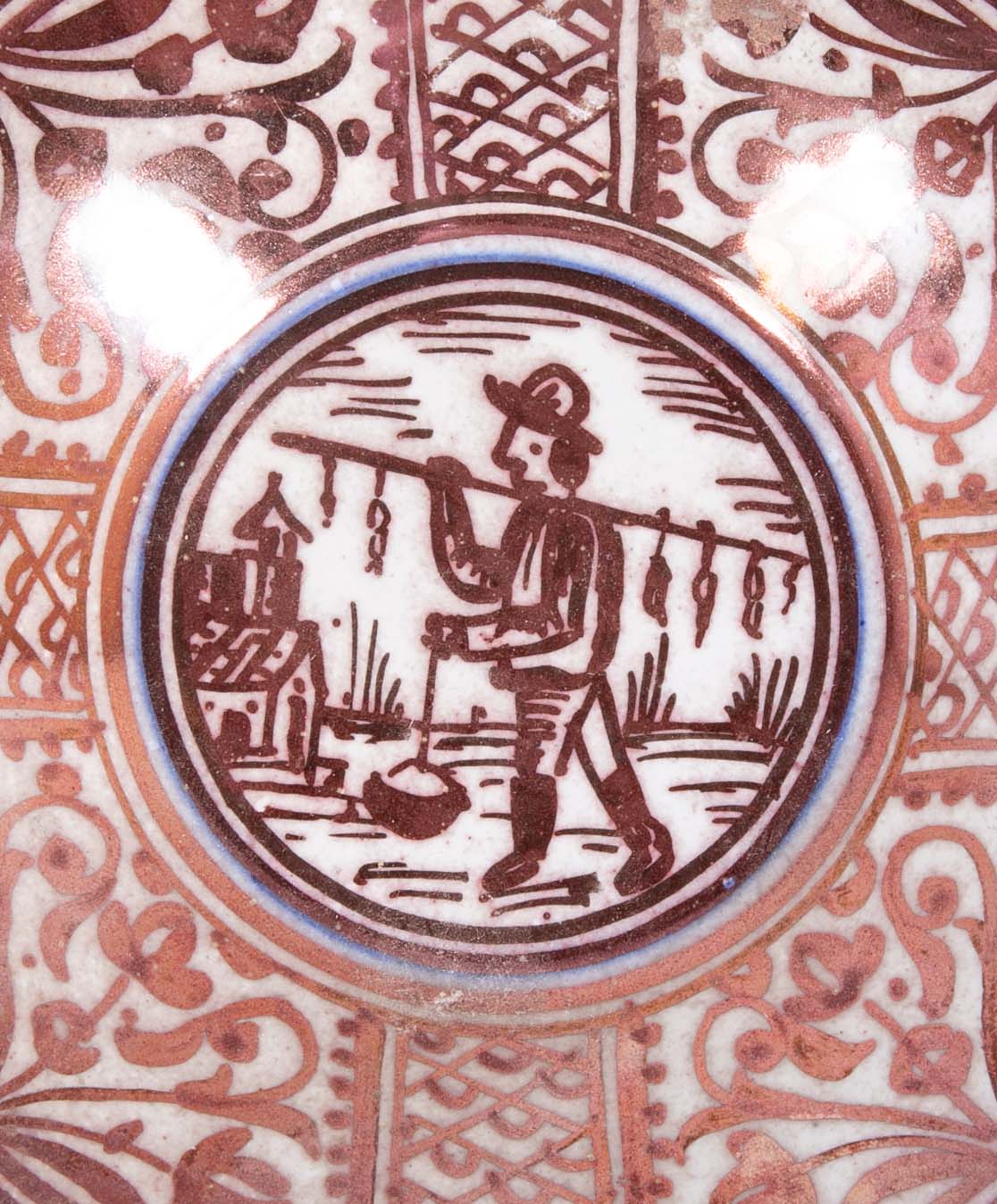 Ruby Lustre Ware Plate with Man Carrying Bird on a Stick
