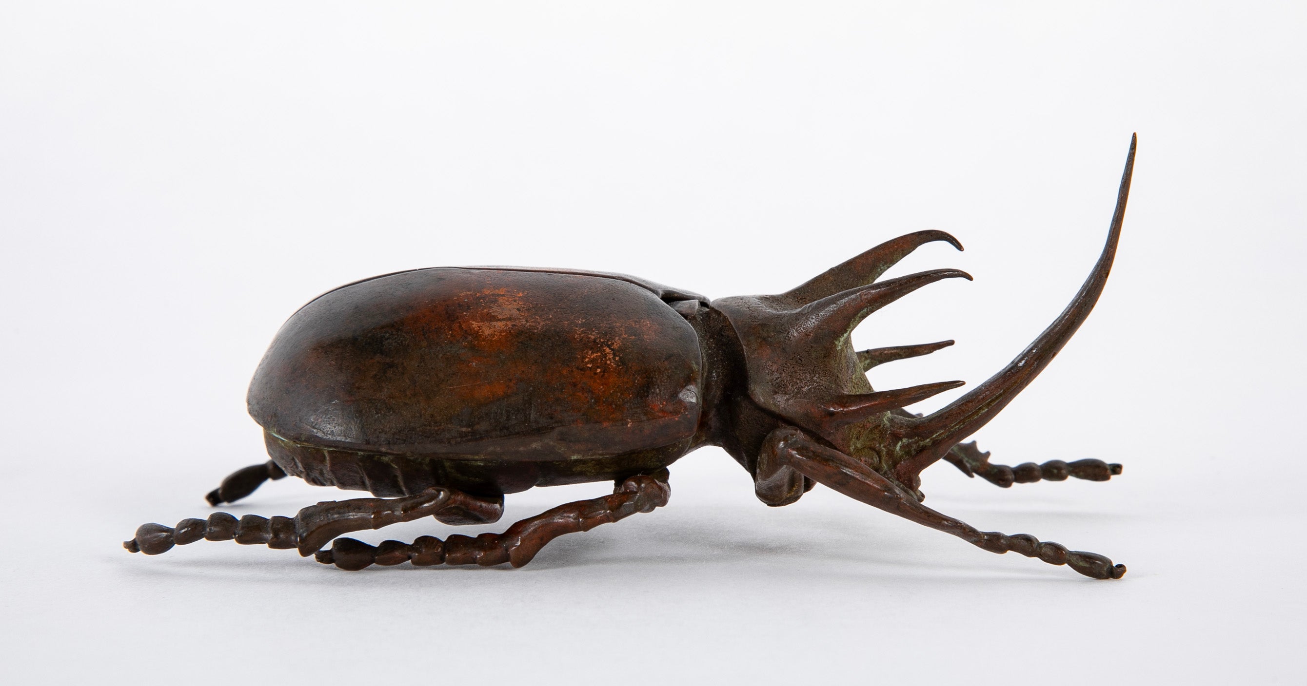A Japanese Patinated Bronze Rhinoceros Beetle with Opening Back