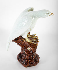 A Japanese White Glazed Porcelain Hawk Perched on a Tree Stump