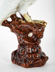 A Japanese White Glazed Porcelain Hawk Perched on a Tree Stump