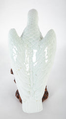 A Japanese White Glazed Porcelain Hawk Perched on a Tree Stump