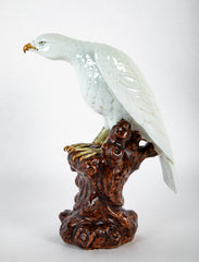 A Japanese White Glazed Porcelain Hawk Perched on a Tree Stump
