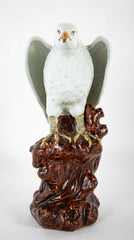 A Japanese White Glazed Porcelain Hawk Perched on a Tree Stump