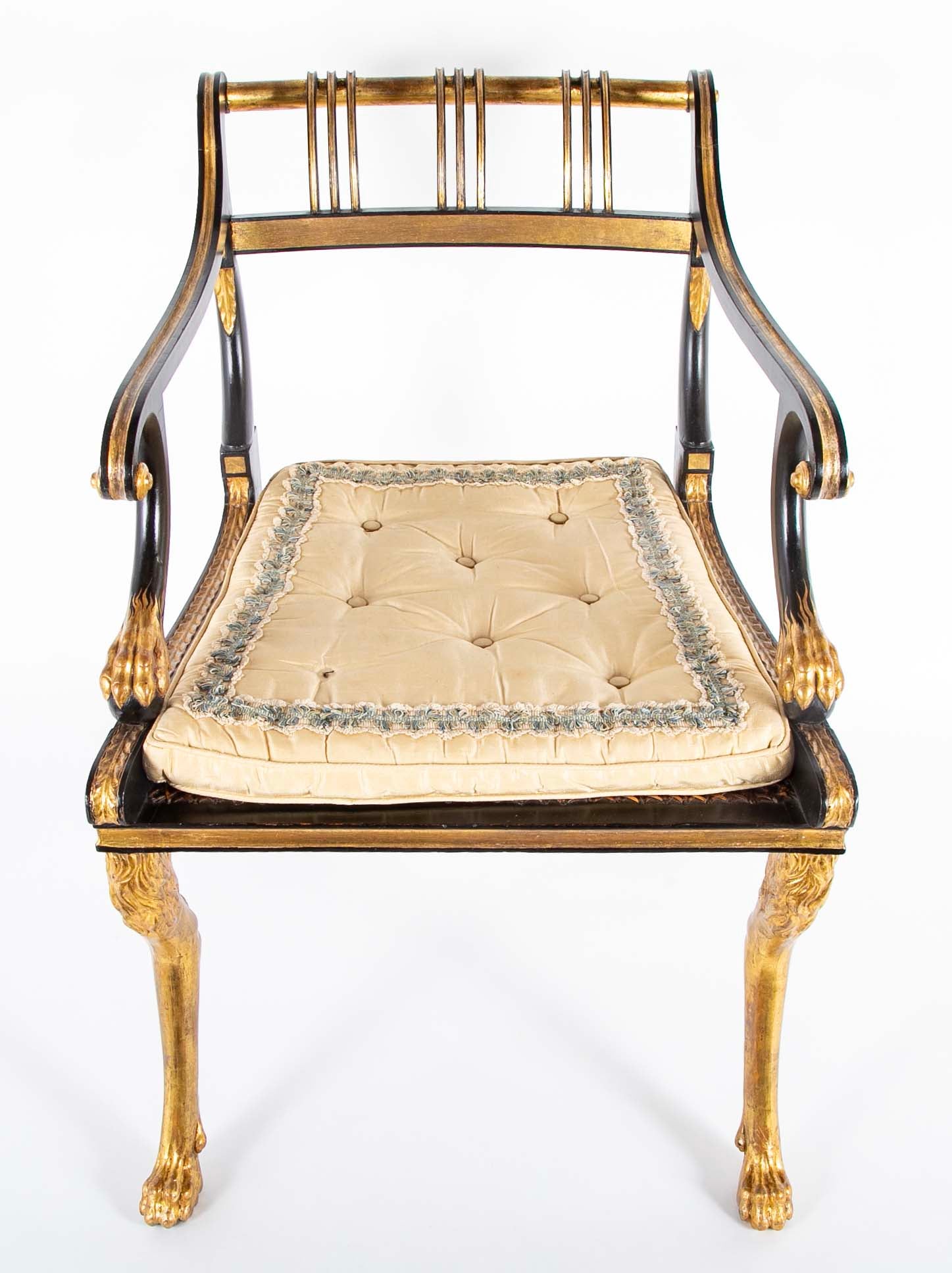 A Pair of Regency Style Ebonized and Parcel Gilt Armchairs