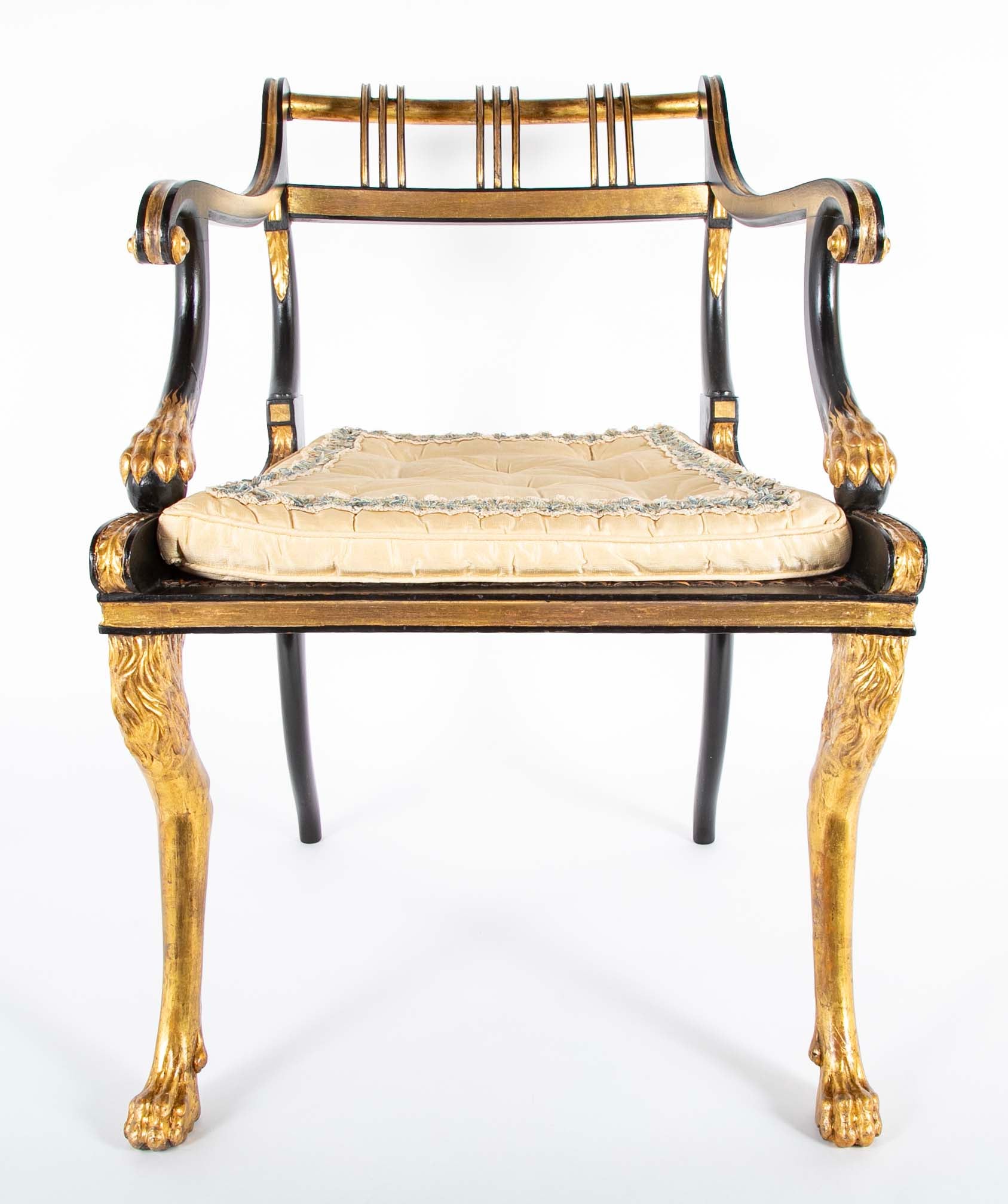 A Pair of Regency Style Ebonized and Parcel Gilt Armchairs