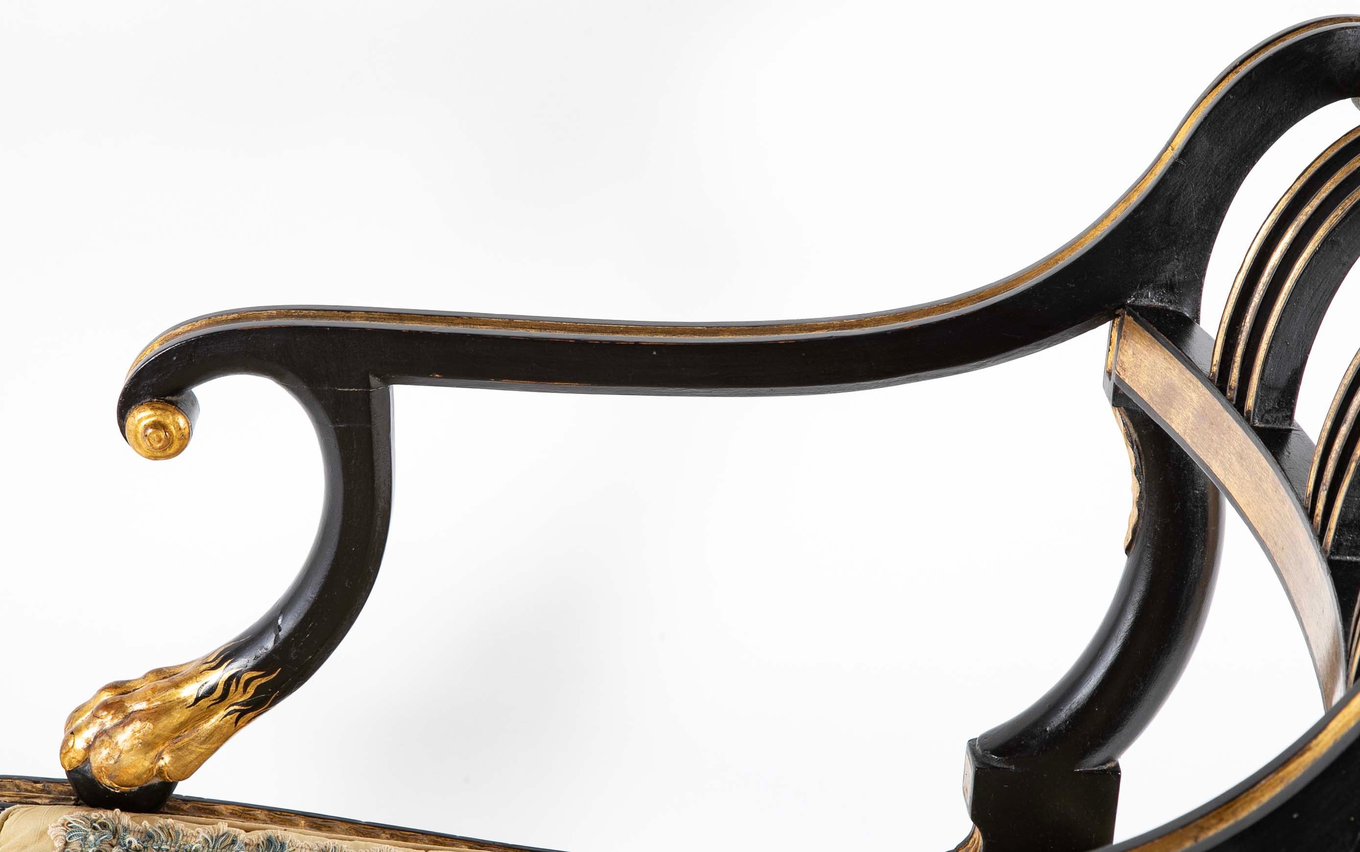 A Pair of Regency Style Ebonized and Parcel Gilt Armchairs