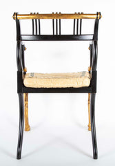 A Pair of Regency Style Ebonized and Parcel Gilt Armchairs