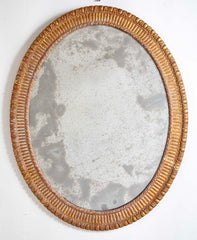 A George III Style Carved Giltwood Oval Mirror