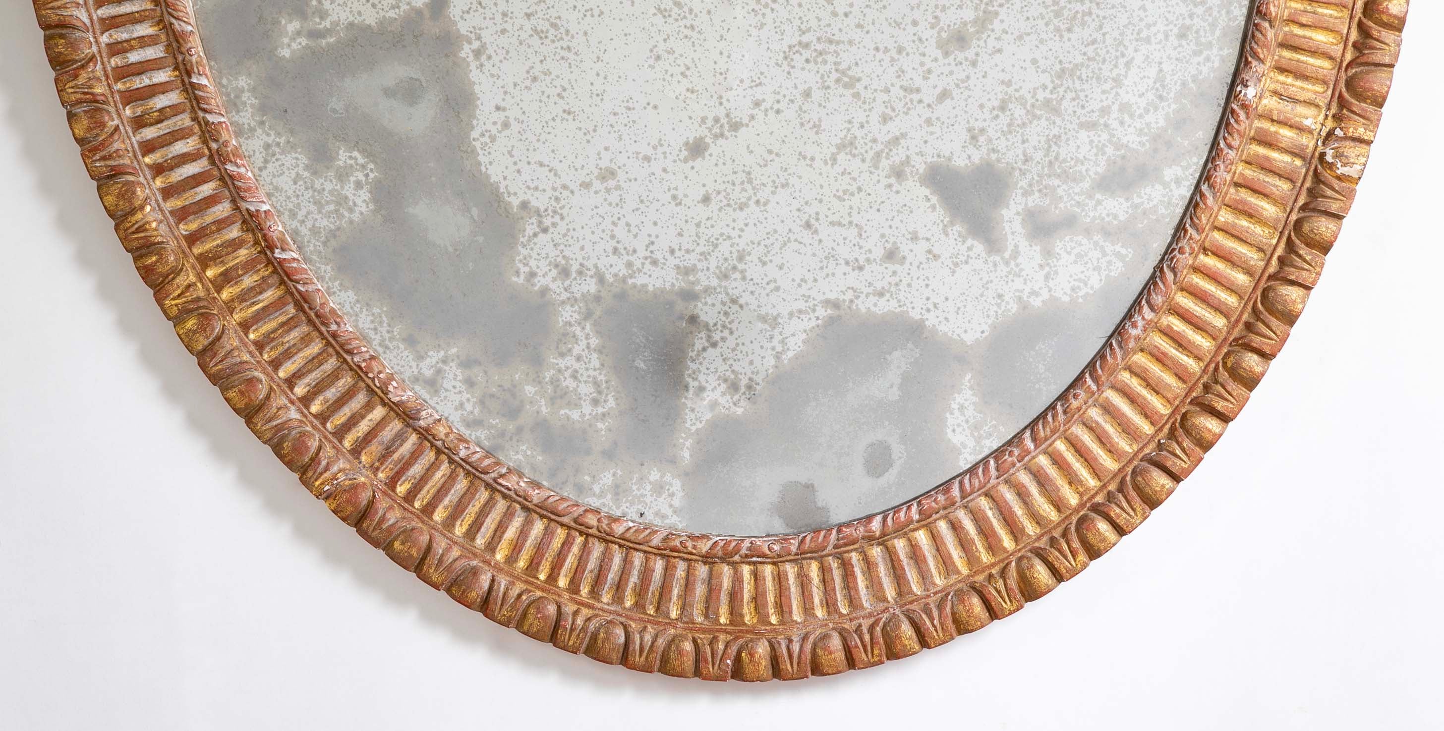 A George III Style Carved Giltwood Oval Mirror