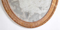 A George III Style Carved Giltwood Oval Mirror