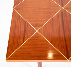 A Tommi Parzinger for Charak Modern Mahogany and Maple Dining Table with Leaves.