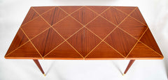 A Tommi Parzinger for Charak Modern Mahogany and Maple Dining Table with Leaves.