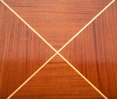A Tommi Parzinger for Charak Modern Mahogany and Maple Dining Table with Leaves.