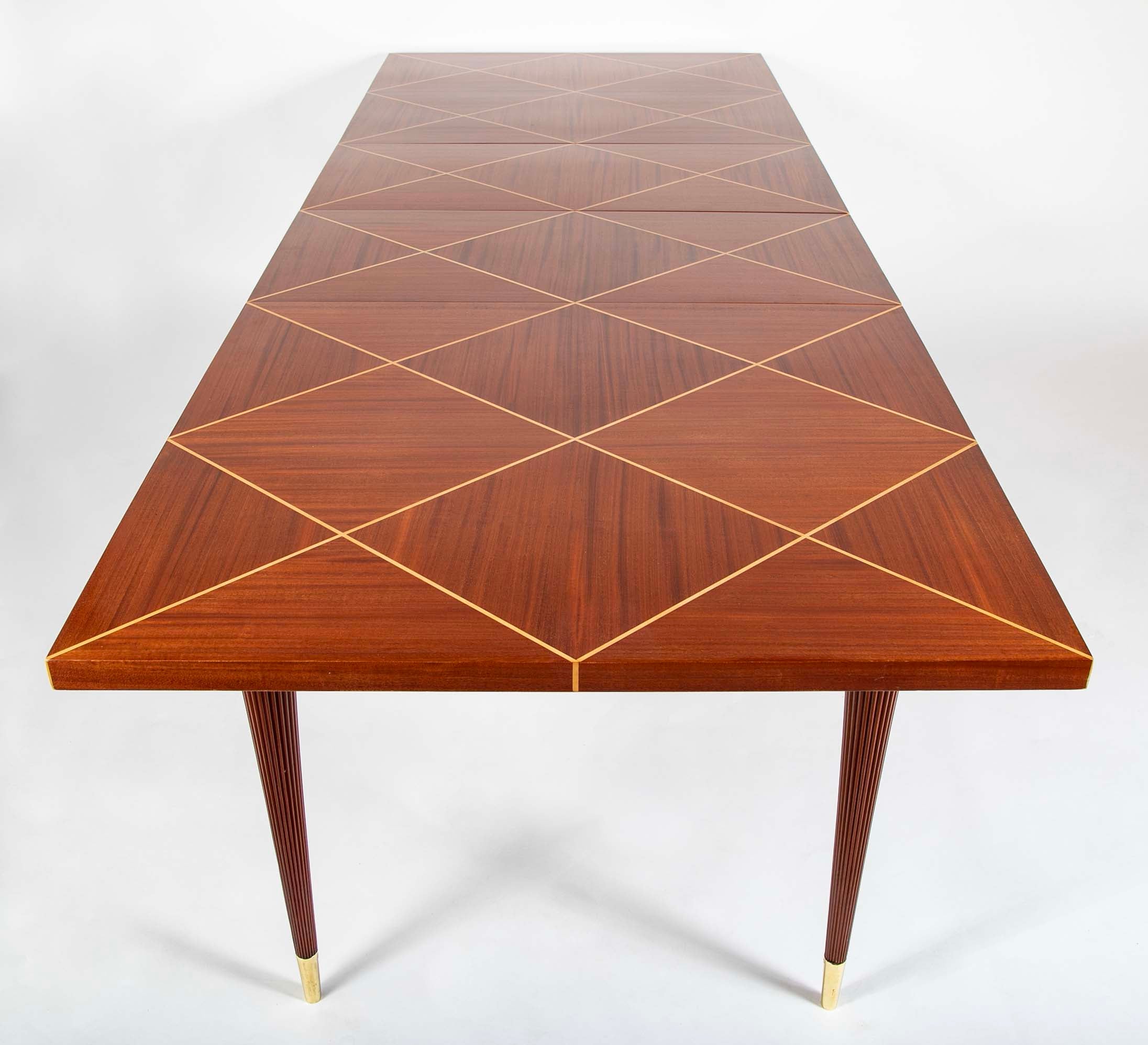 A Tommi Parzinger for Charak Modern Mahogany and Maple Dining Table with Leaves.