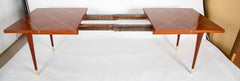 A Tommi Parzinger for Charak Modern Mahogany and Maple Dining Table with Leaves.