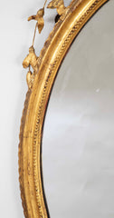 English George III Oval Hepplewhite Gilded Mirror with Ram's Head Surmount