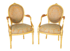 A Pair of George III Period Giltwood Oval Back "Elbow" Chairs