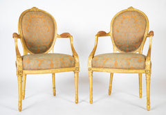 A Pair of George III Period Giltwood Oval Back "Elbow" Chairs