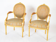 A Pair of George III Period Giltwood Oval Back "Elbow" Chairs