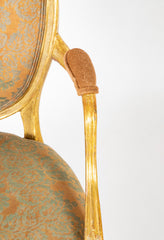 A Pair of George III Period Giltwood Oval Back "Elbow" Chairs