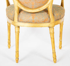 A Pair of George III Period Giltwood Oval Back "Elbow" Chairs