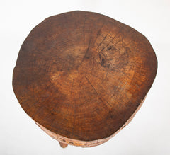 A Rustic Tripod Form Side Table with Tree Cross Section as Top