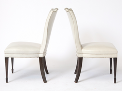A Set of 12 Leather and Close Chrome Nailed Dining Chairs