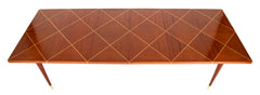 A Tommi Parzinger For Charak Modern Mahogany and Maple Dining Table With Leaves.