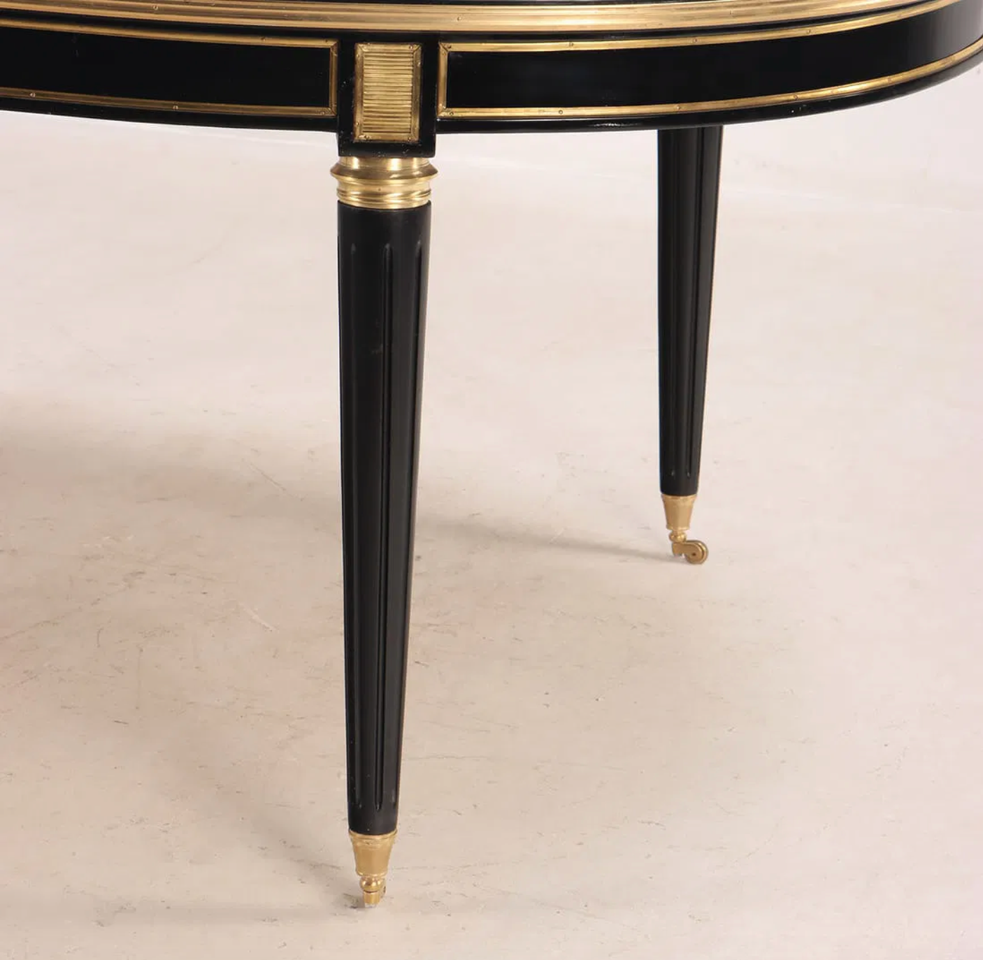 A Jansen Style Ebonized and Bronze Mounted Dining Table