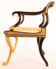 A Pair of Regency Style Ebonized and Parcel Gilt Armchairs