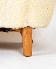 A Danish Two Seat Curved Sofa with Faux Sheepskin Upholstery