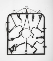 A Garden Gate in Wrought Iron with Antique Farm Tools by Rodney Rosebrook