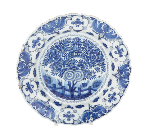 A Delft Blue & White Charger Depicting Blossoms from a Rock